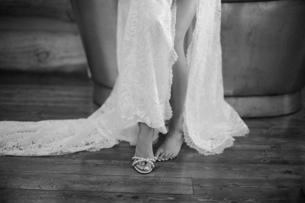 bride slipping on wedding shoes