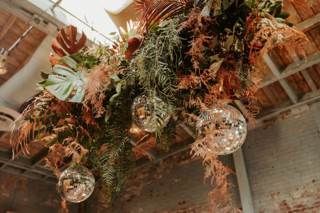 Botanical wedding details with disco balls