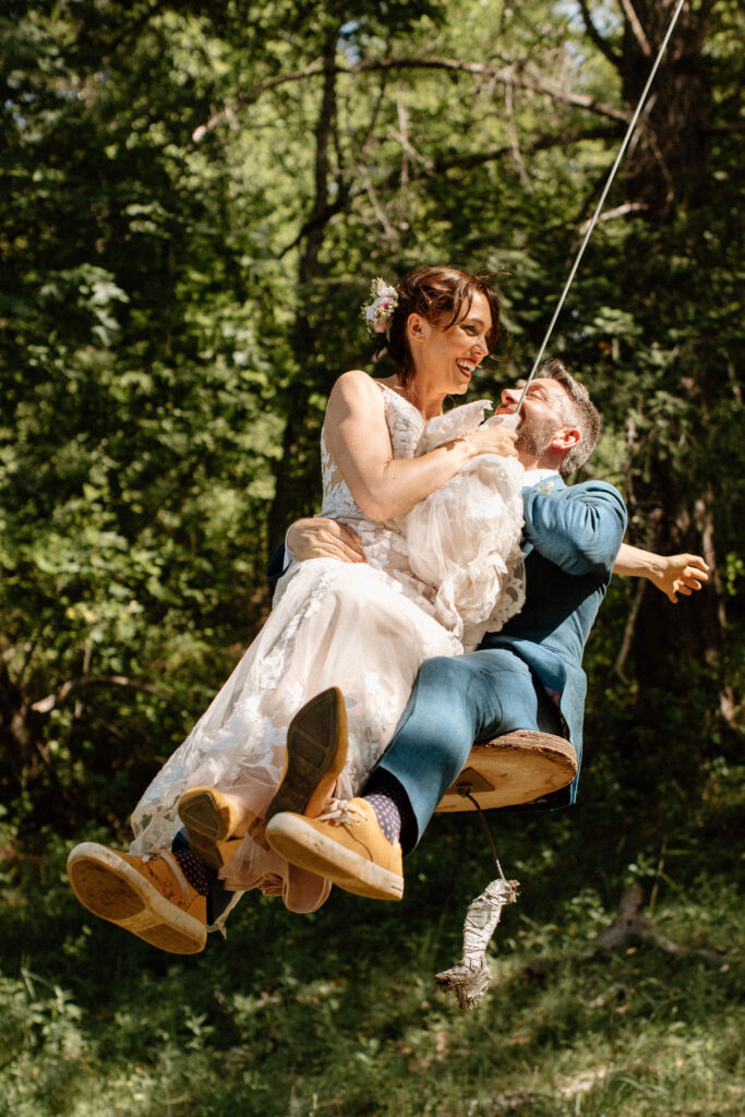 Bride and groom swinging on a rope seat