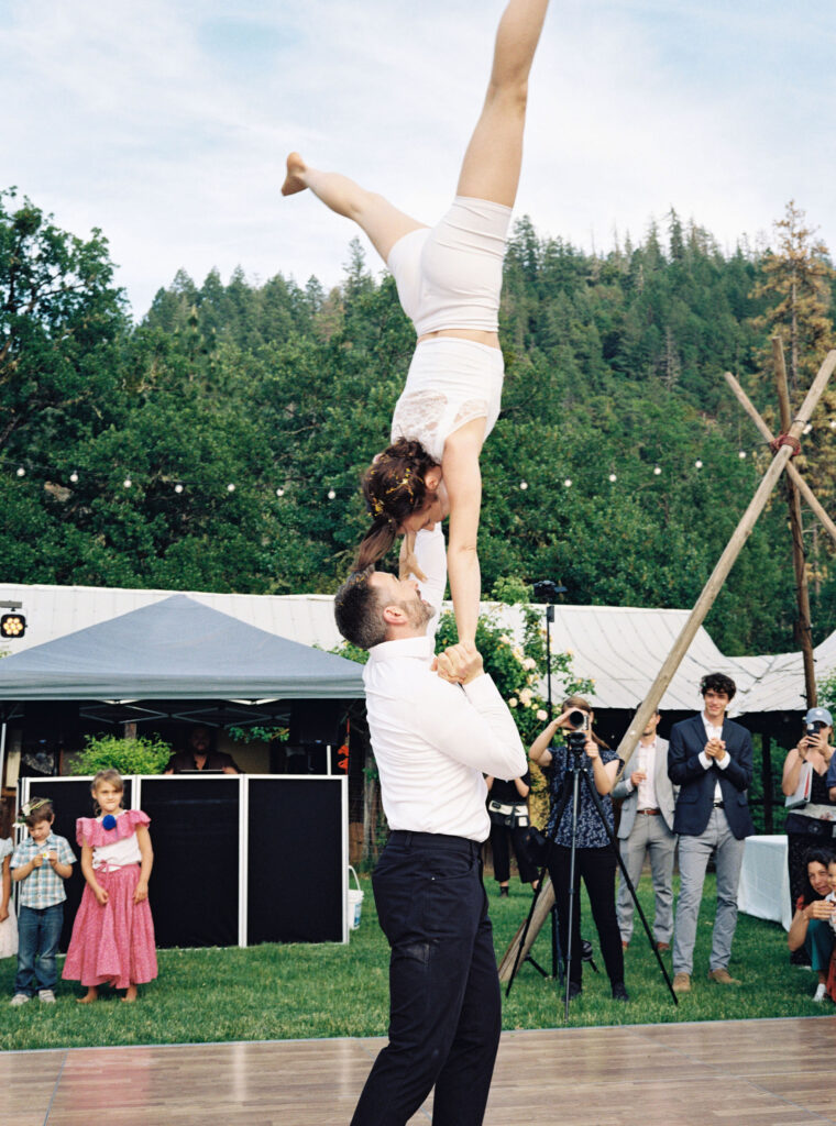 Bride and groom doing acrobats during wedding reception
