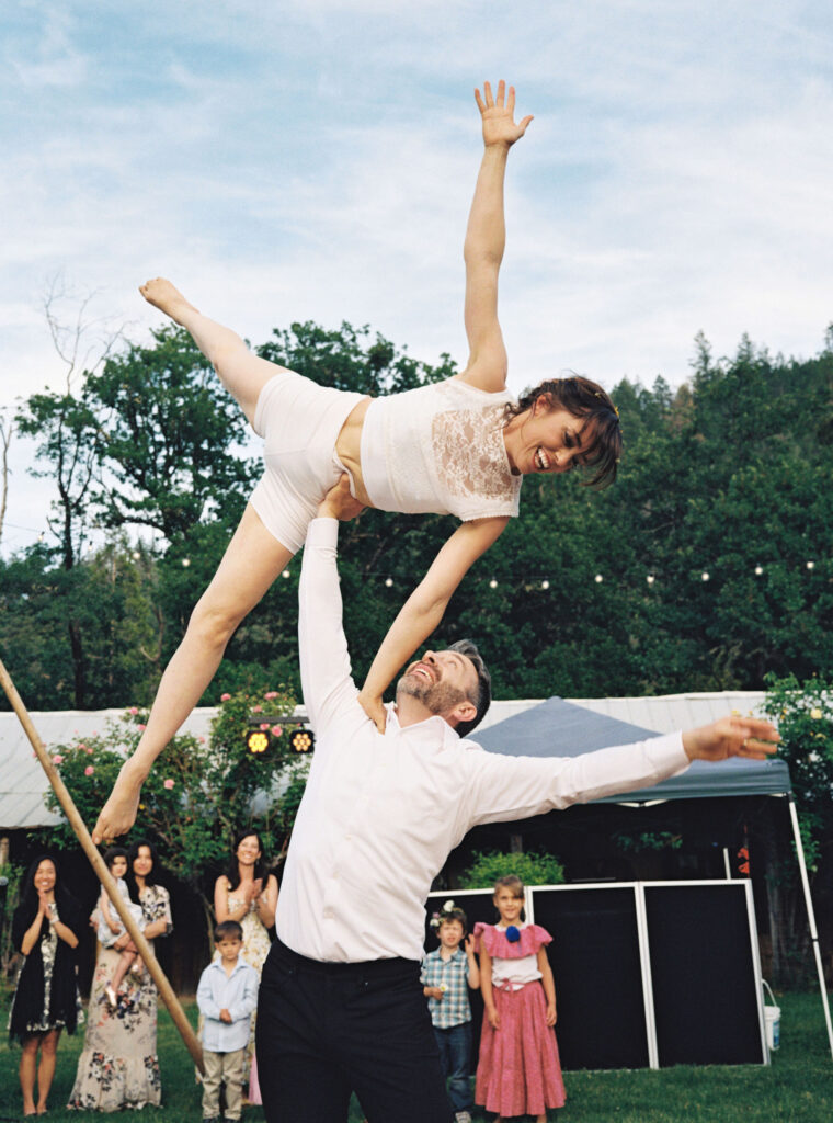 Bride and groom doing acrobat during their wedding reception