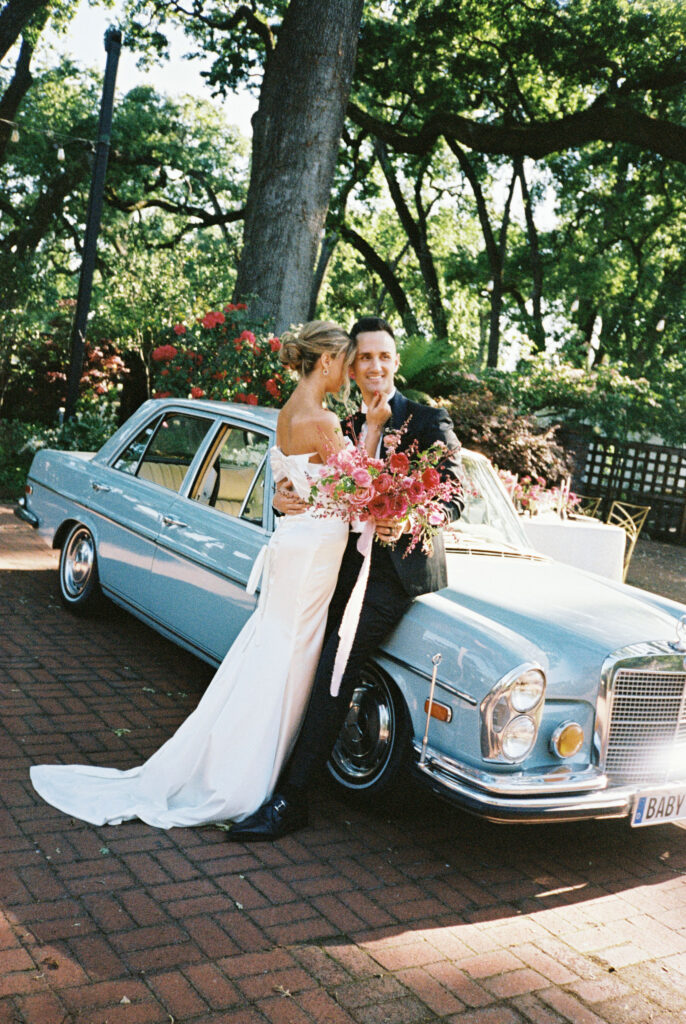 Bride and groom with vintage car
