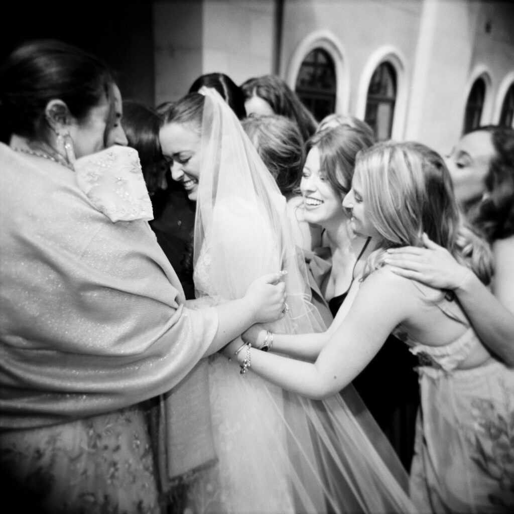 Bride hugging wedding guests after ceremony