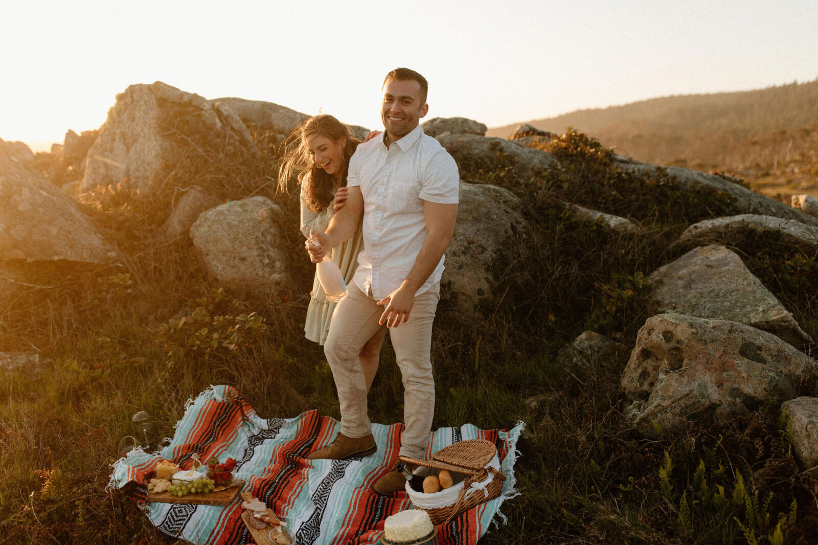 Couples Sonoma coast engagement photos with a picnic