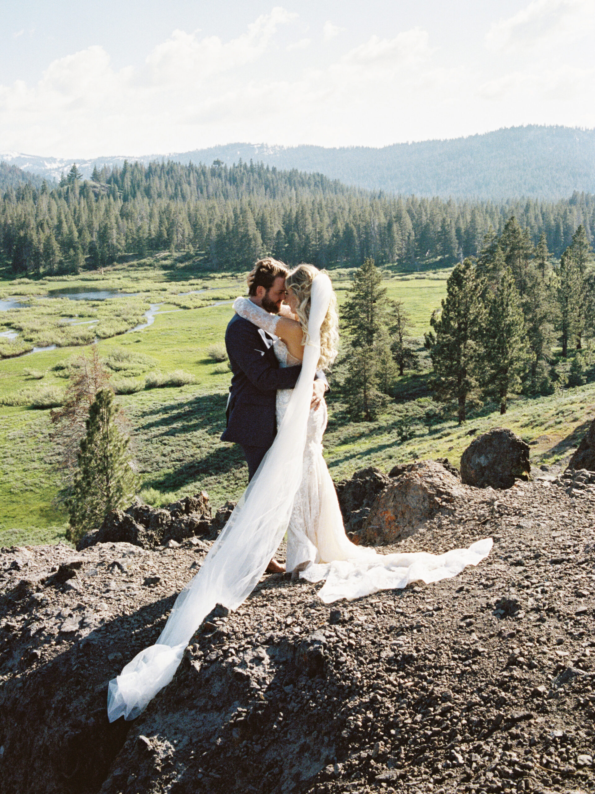 stunning bride and groom pose with the valley in the background