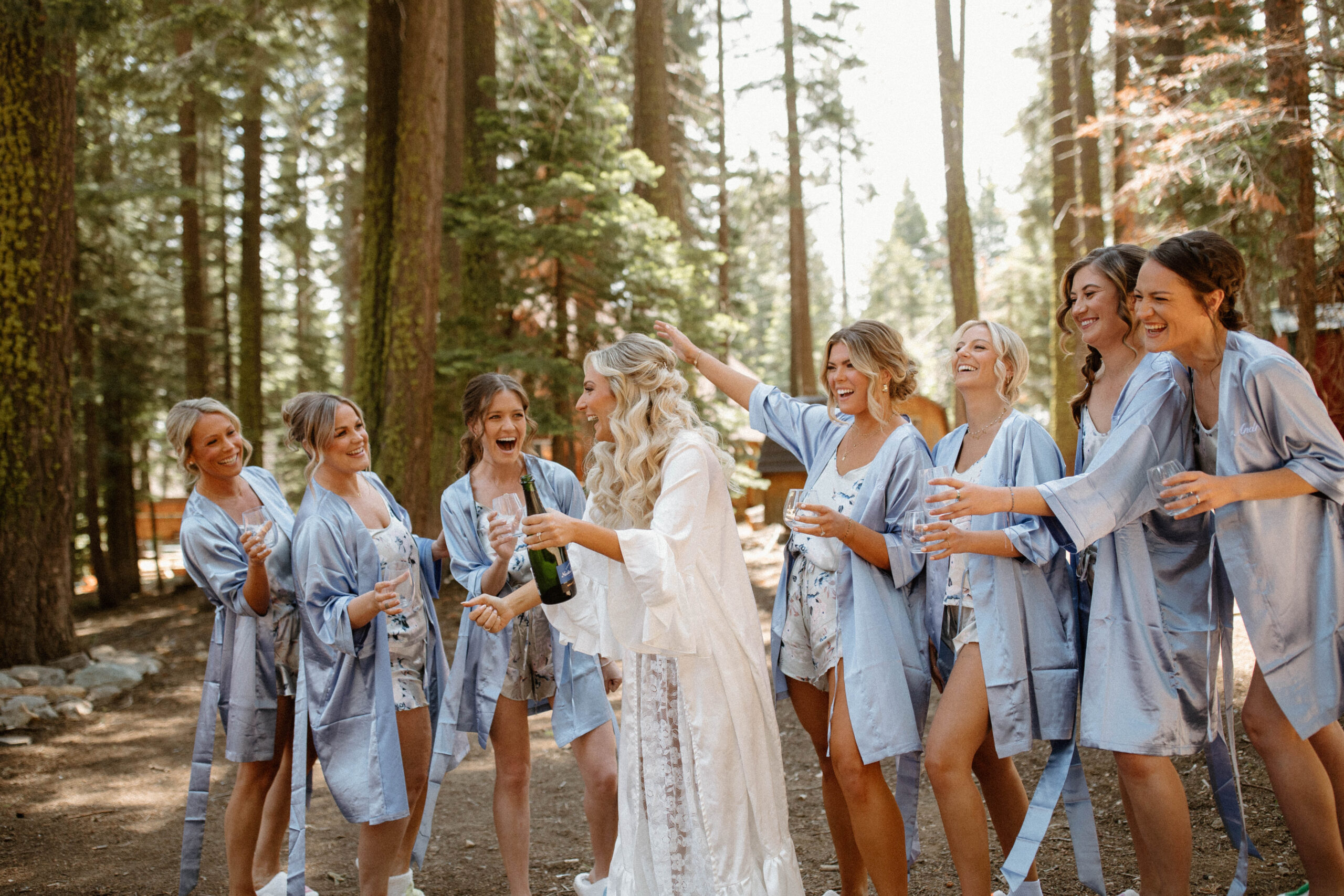 bridesmaids celebrate with the bride as they all share a glass of champagne 