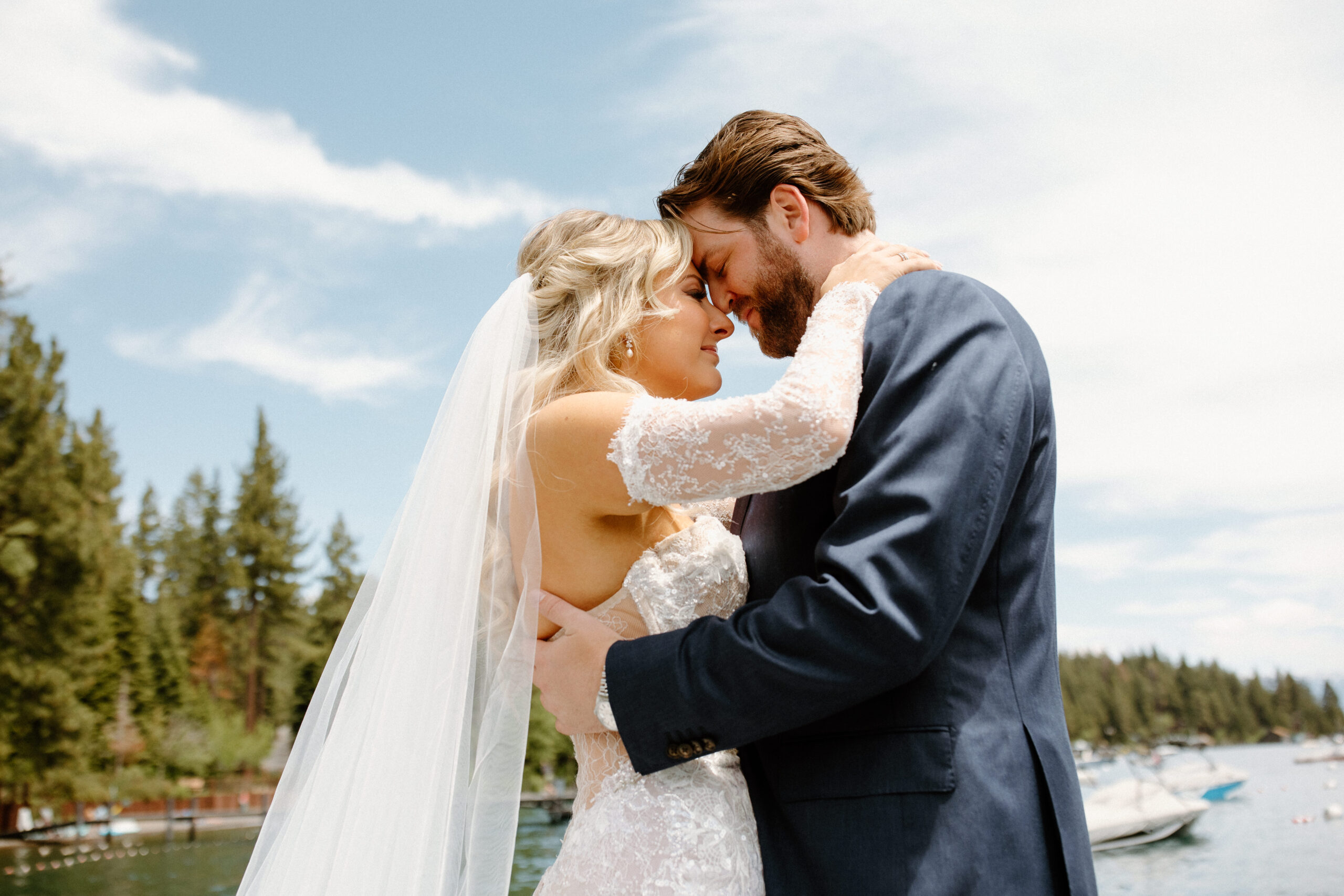 beautiful bride and groom pose on the lake tahoe dock 