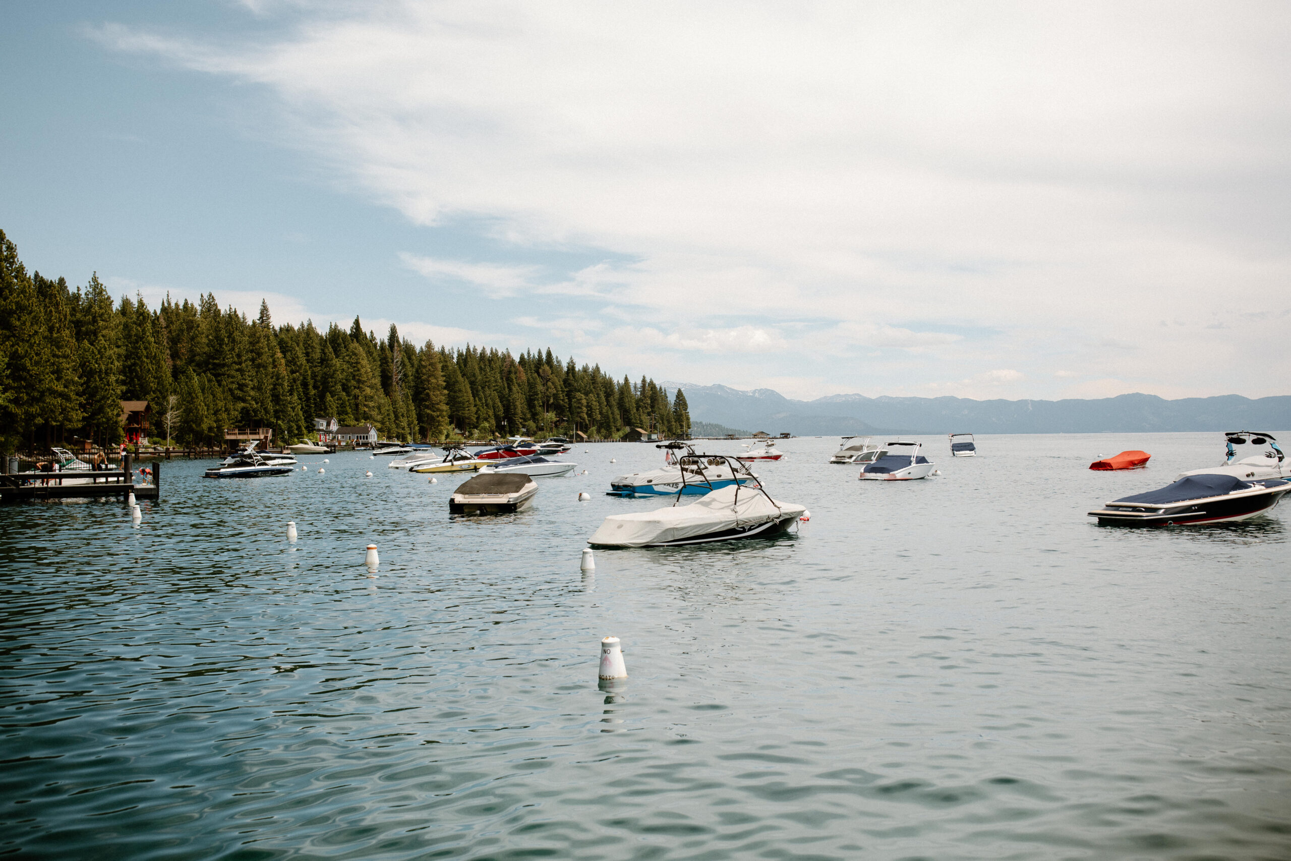 stunning lake tahoe views with boats dotting the water and the mountains in the background