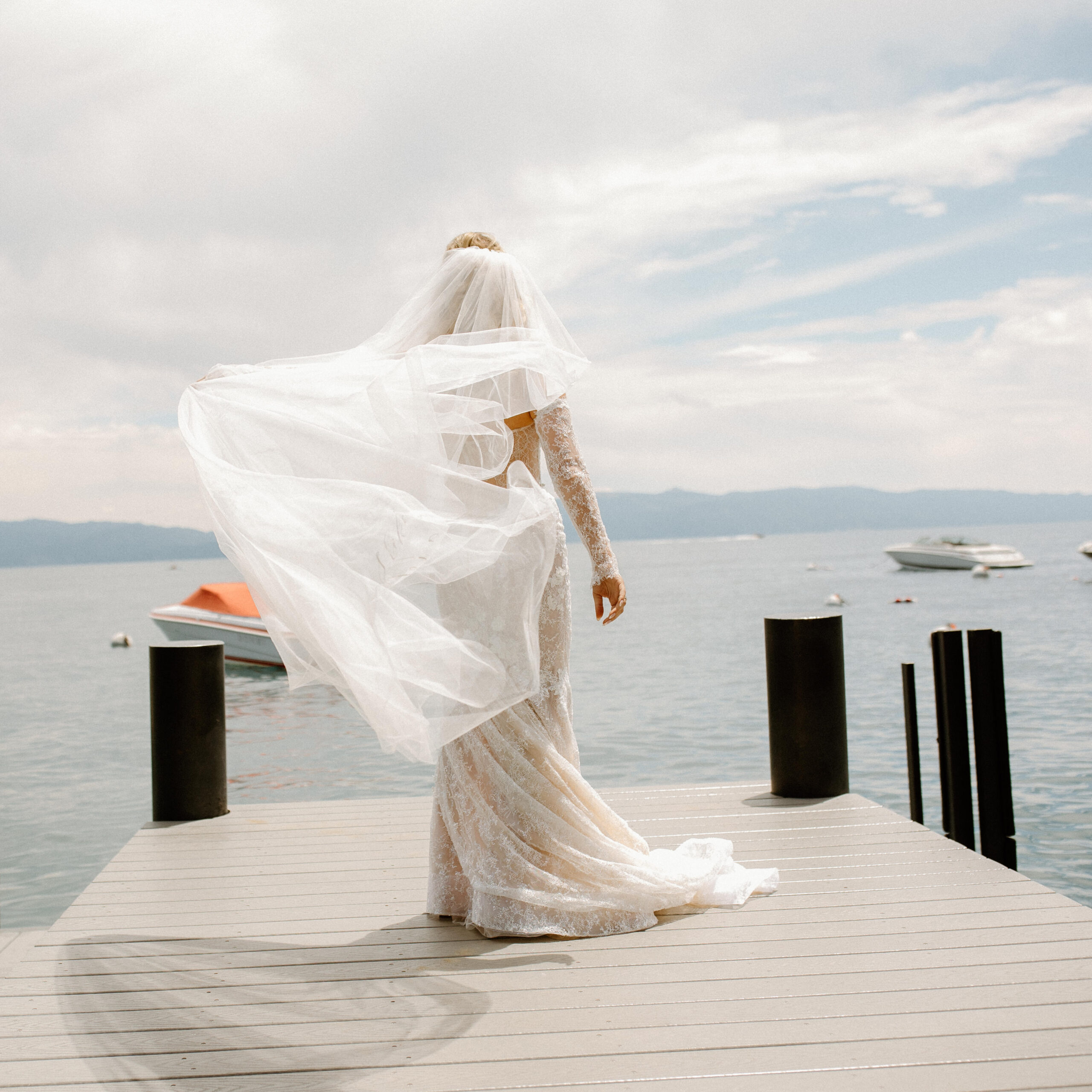 beautiful bride poses on the lake tahoe dock