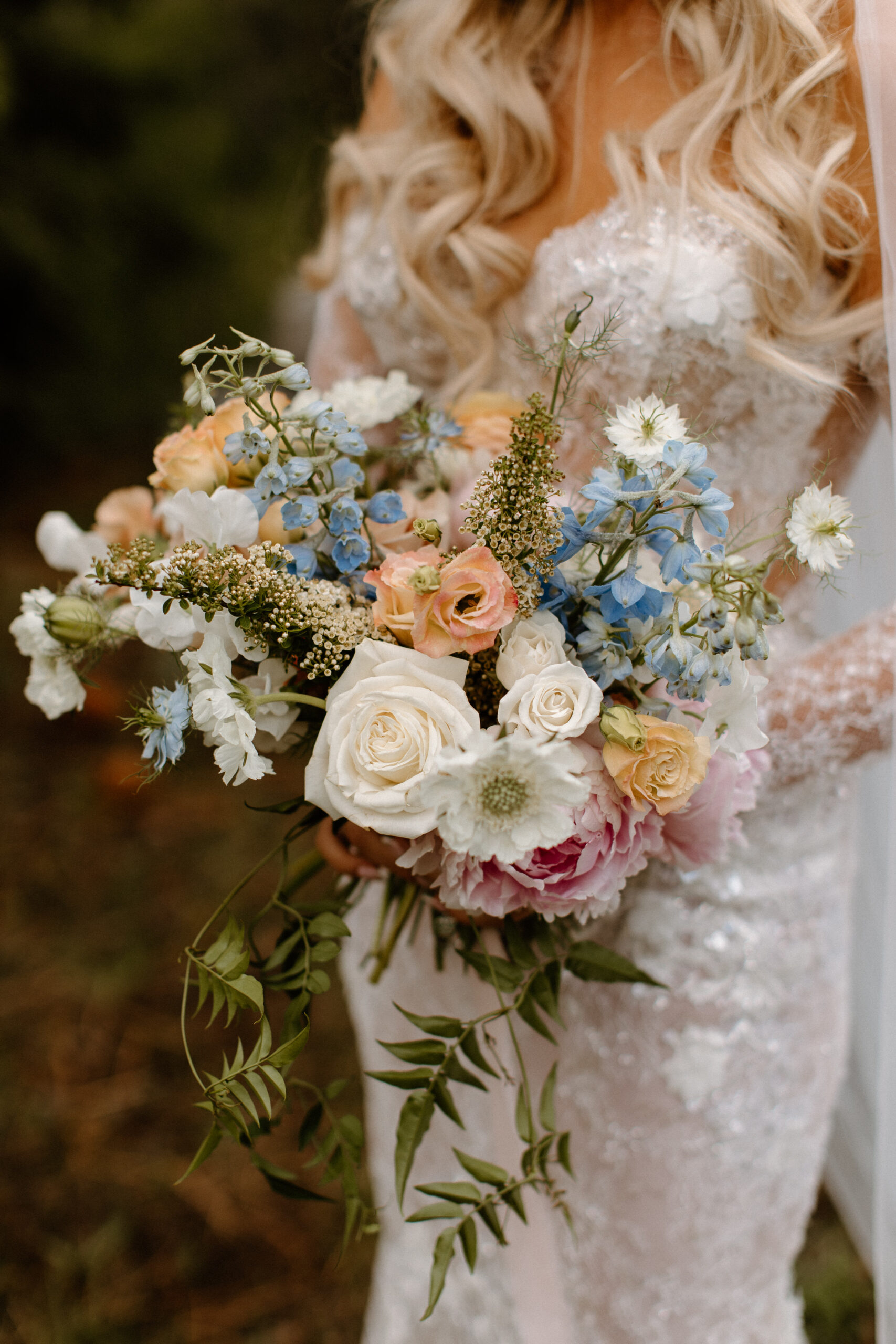 bride showcases her wedding bouquet 