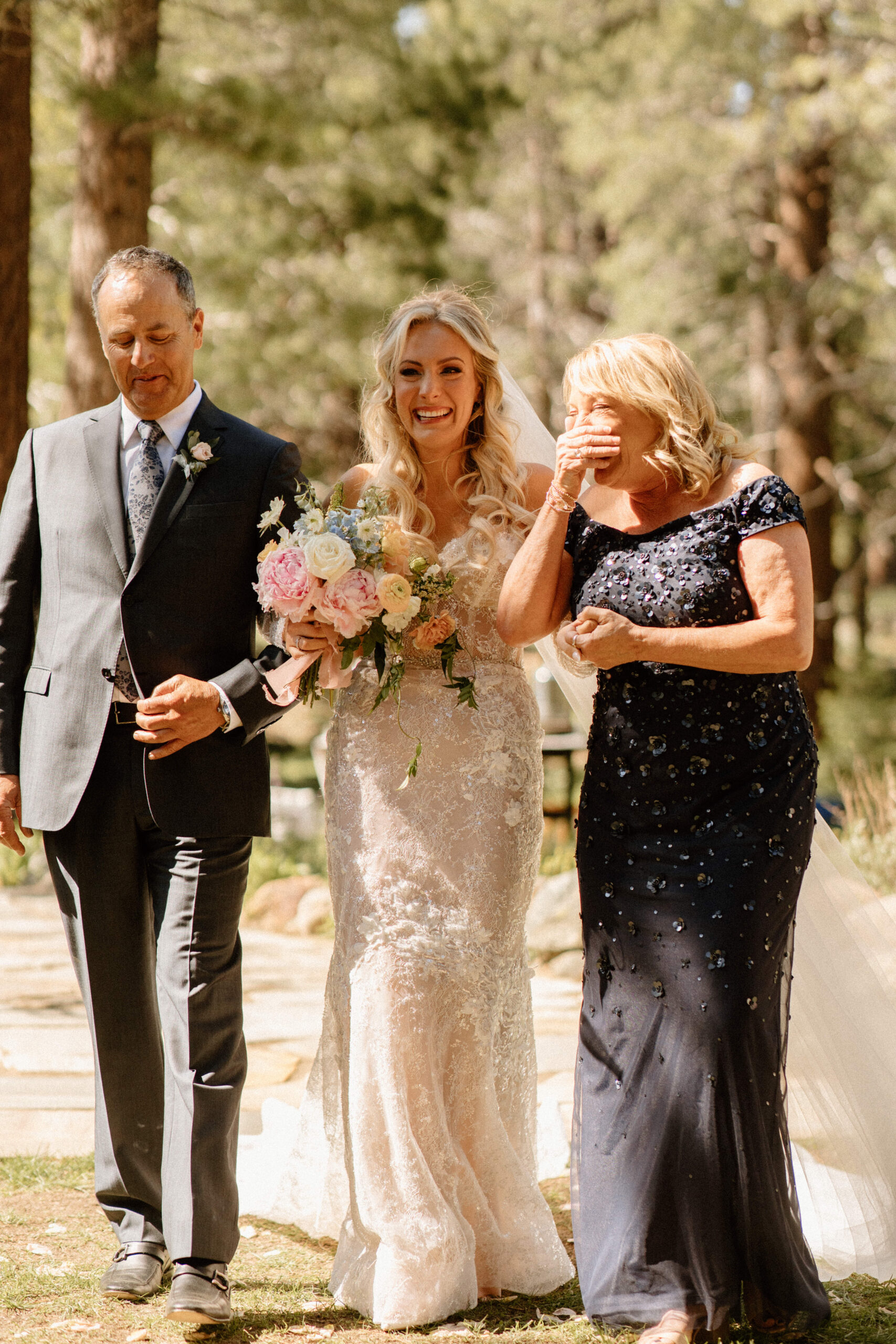 beautiful bride gets walked down the aisle by her lovely parents 