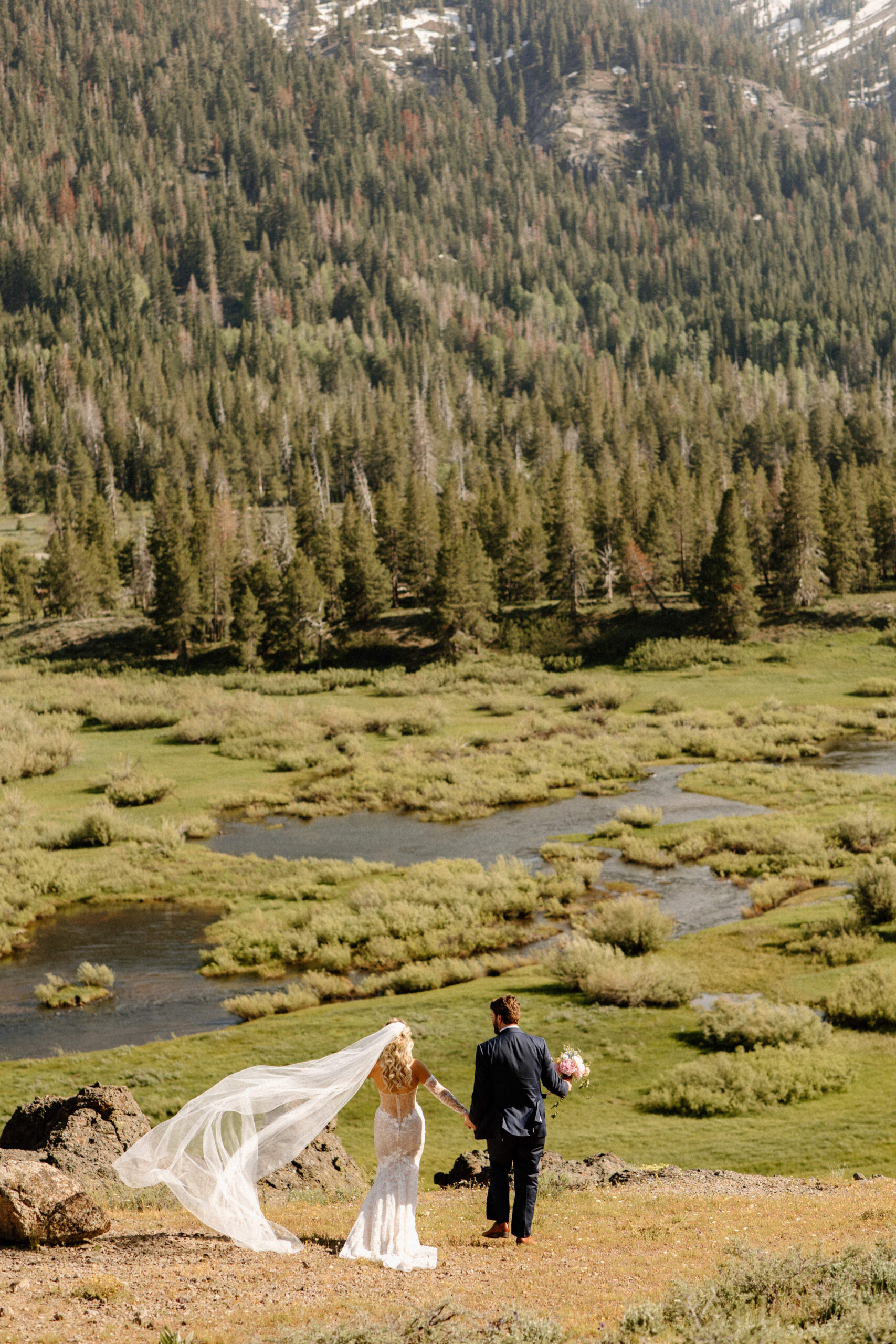 stunning bride and groom pose with the valley in the background after their dreamy Lake Tahoe Wedding at Dancing Pines