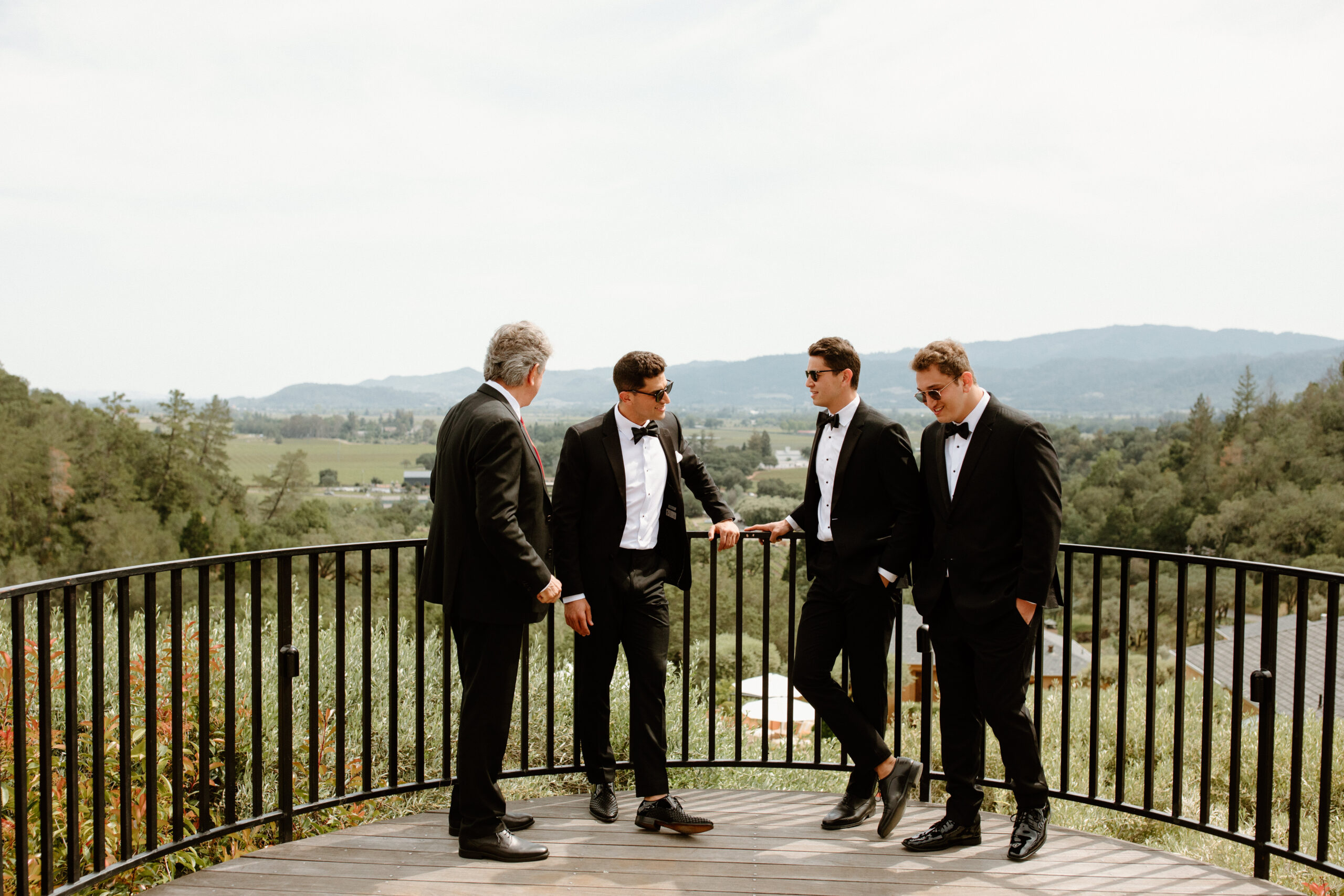 groom poses with his groomsmen before his California wedding day