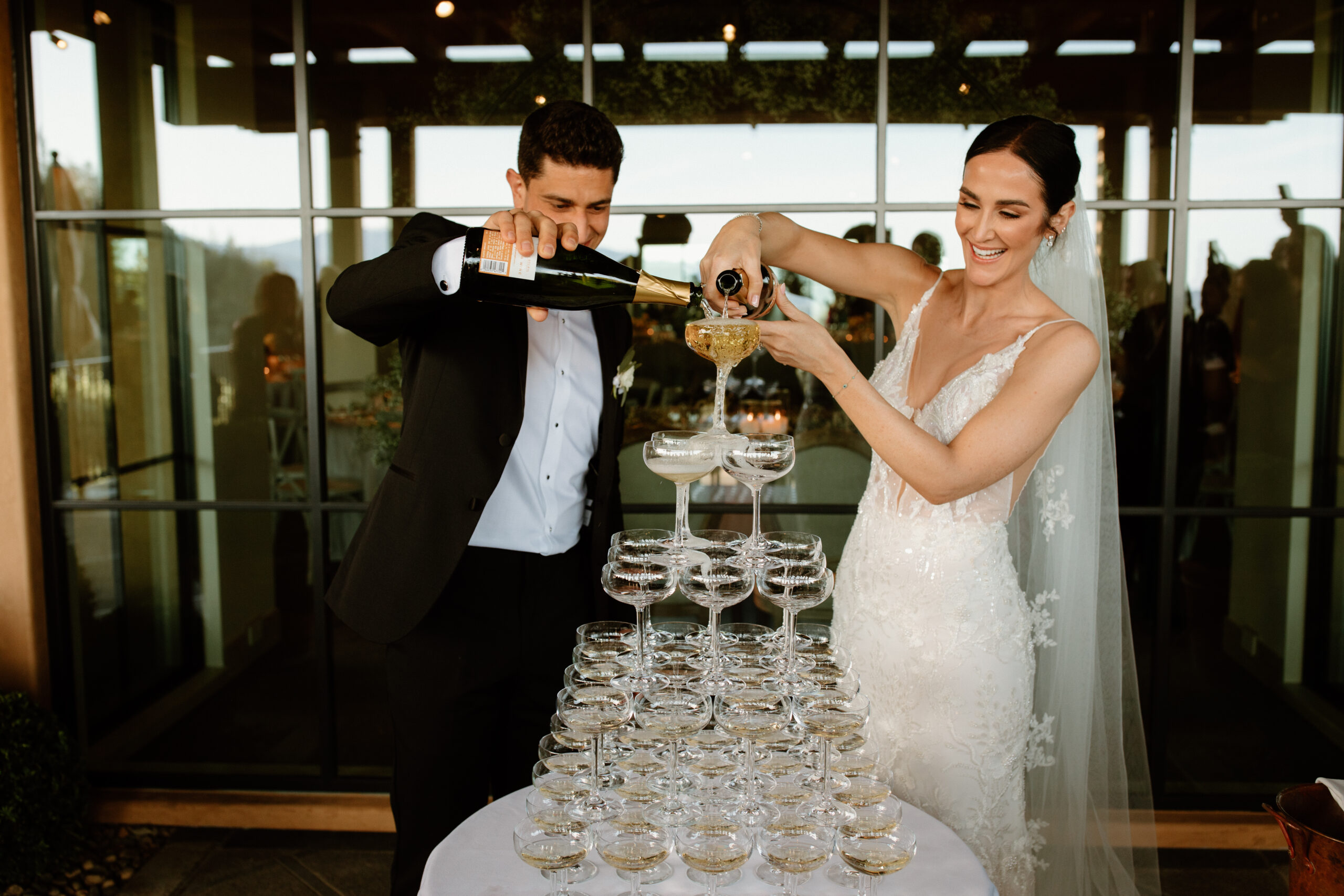 bride and groom celebrate with their classy champagne tower