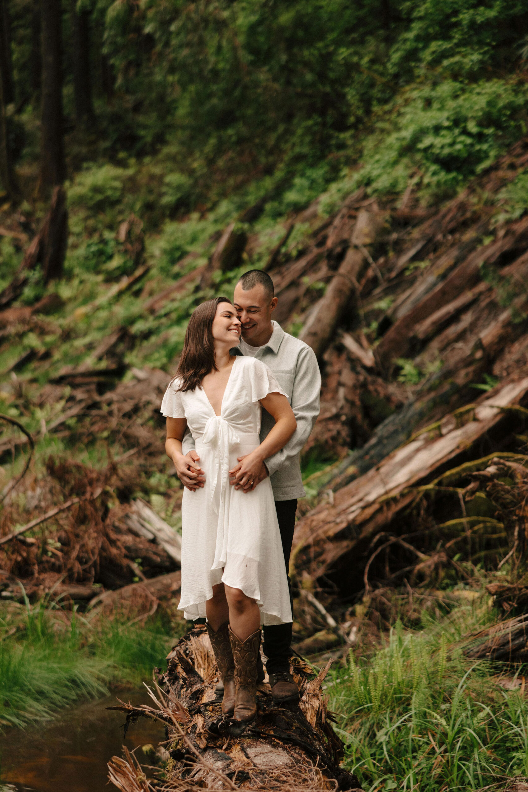 stunning couple pose amongst the gigantic Redwood trees during their documentary style Redwood forest engagement photoshoot