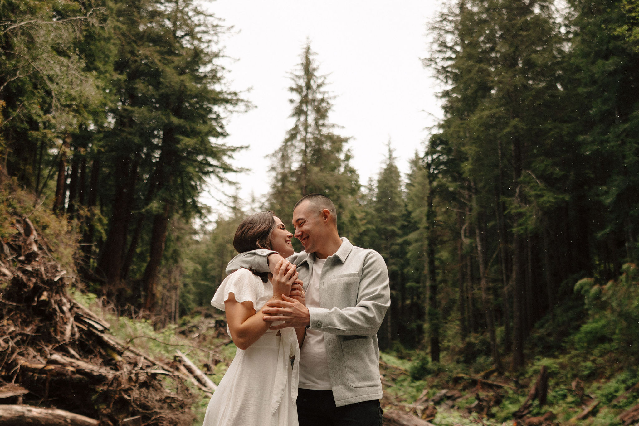 stunning couple pose amongst the gigantic Redwood trees during their documentary style northern california engagement photos