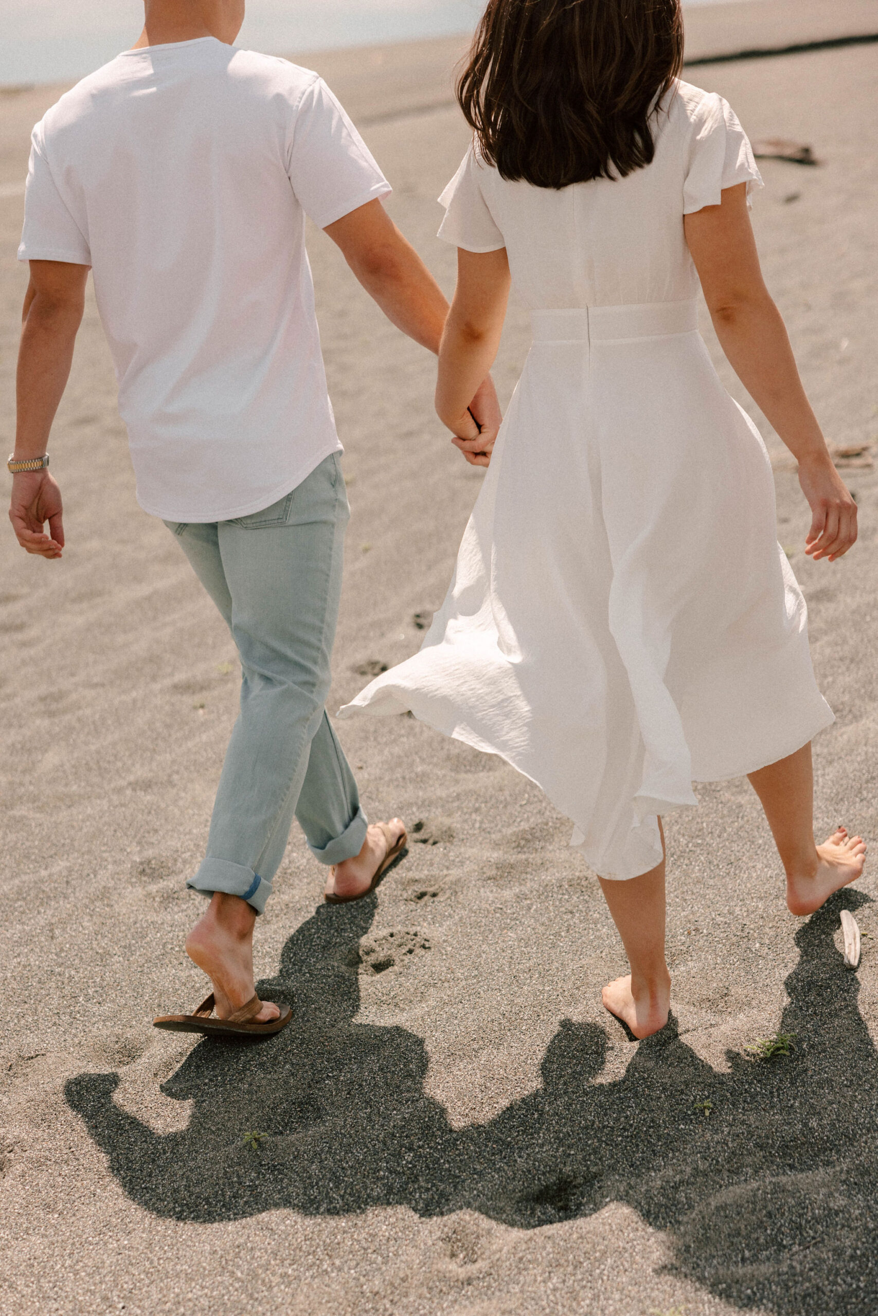 couple walk together on the California coast