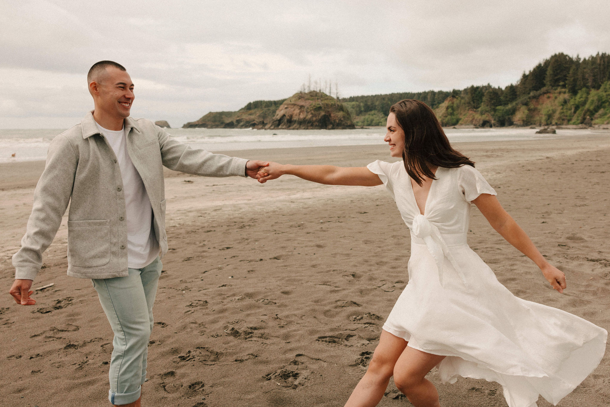 couple pose together on the California coast