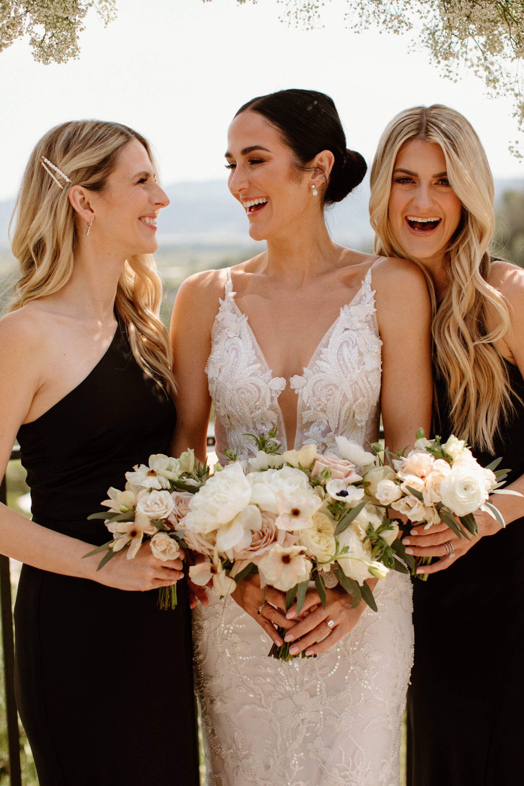 bride poses with her bridesmaids before her dreamy California wedding ceremony