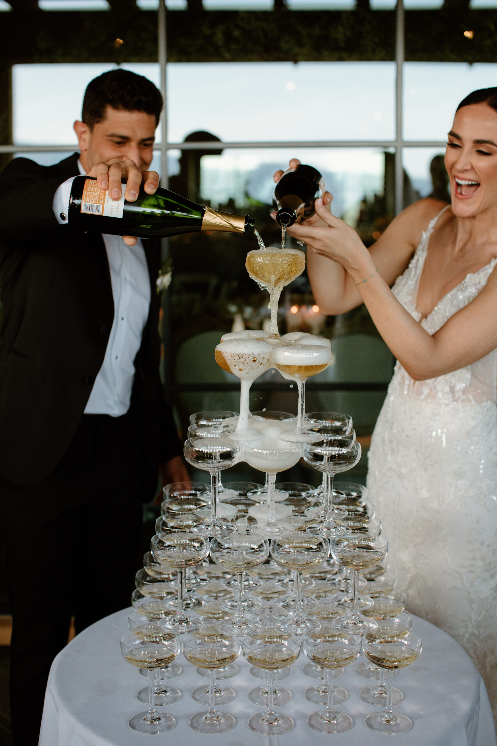 bride and groom celebrate with their classy champagne tower