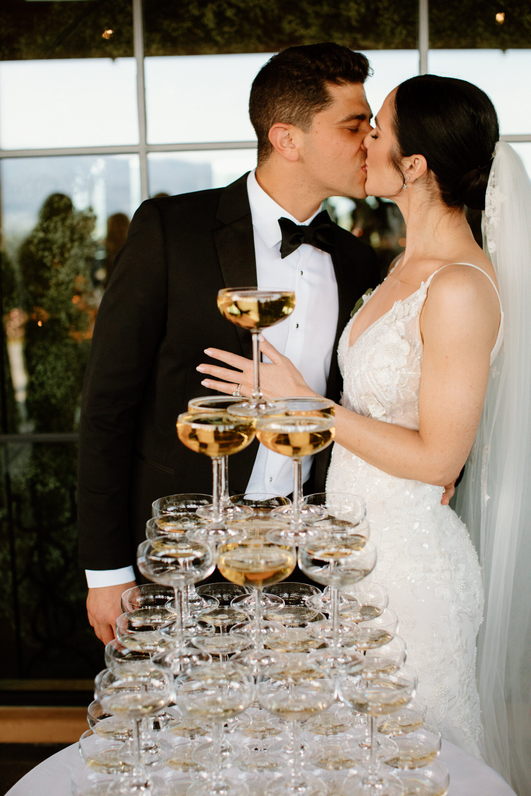 bride and groom celebrate with their classy champagne tower