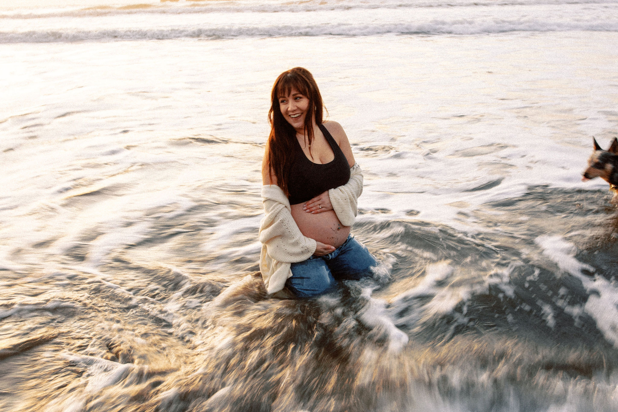 future mom poses on the coast