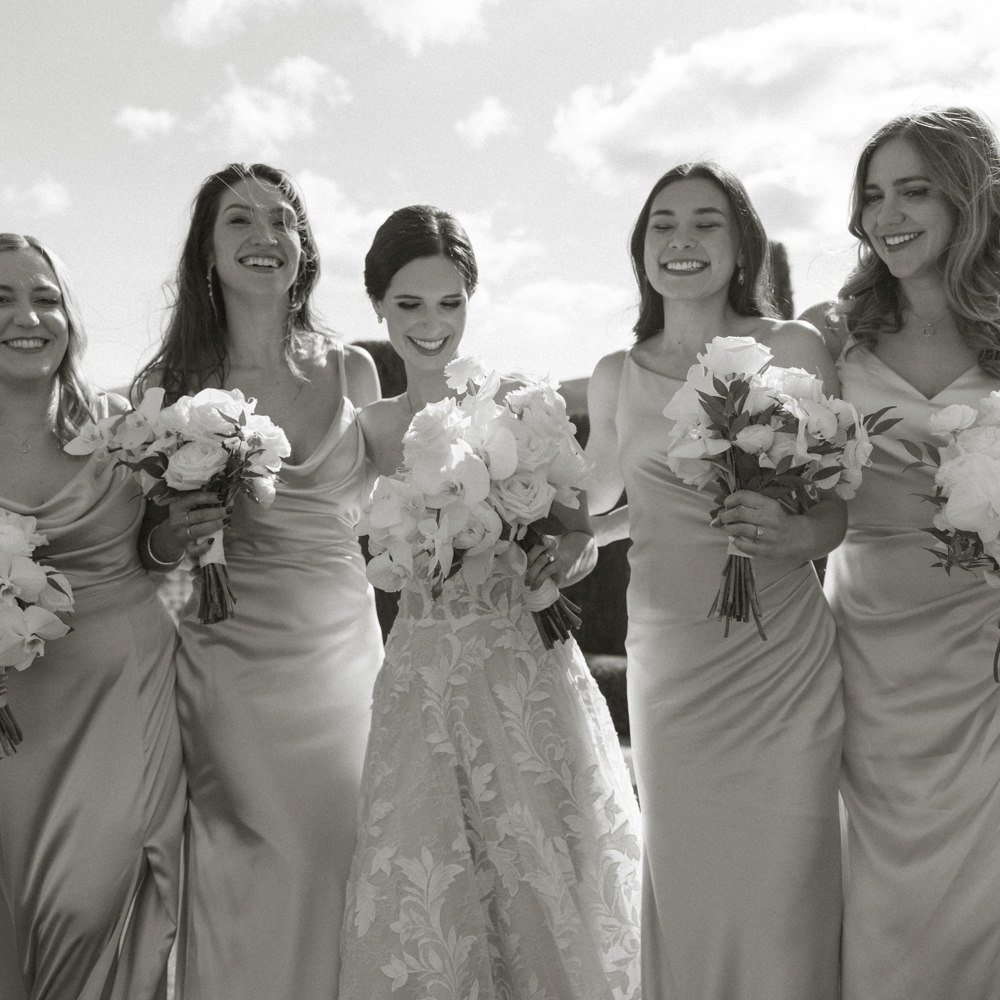 bridesmaids share a laugh with the bride