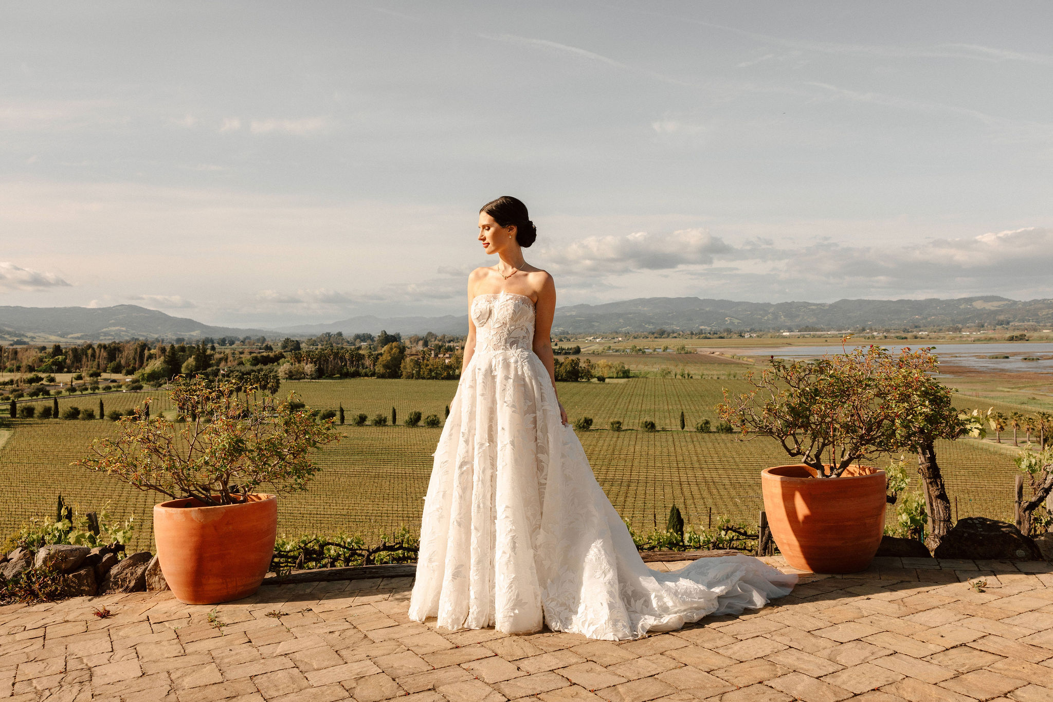 stunning bride poses with the California winery in the background