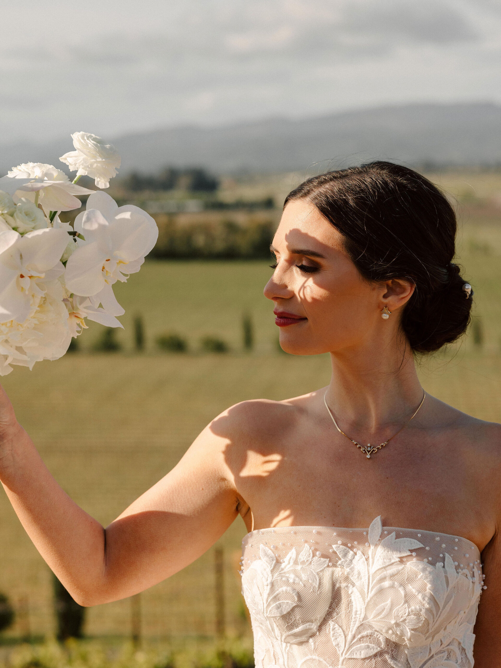 stunning bride poses with the California winery in the background