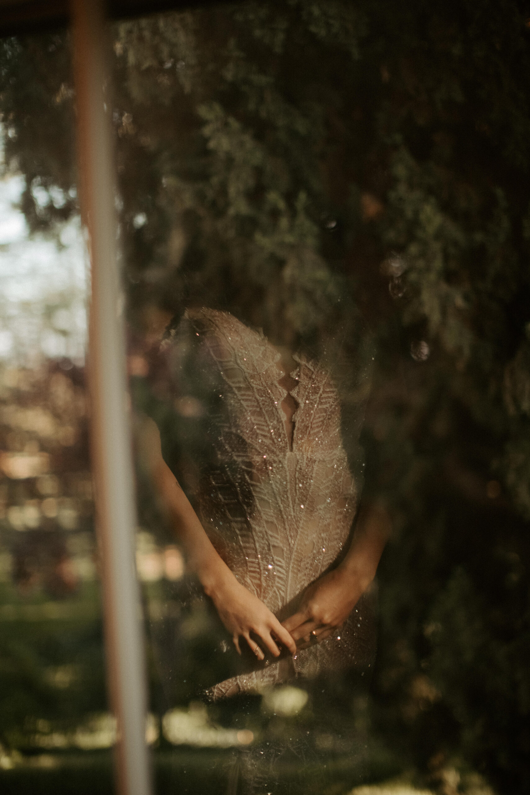 bride looks through the window during her California wedding day