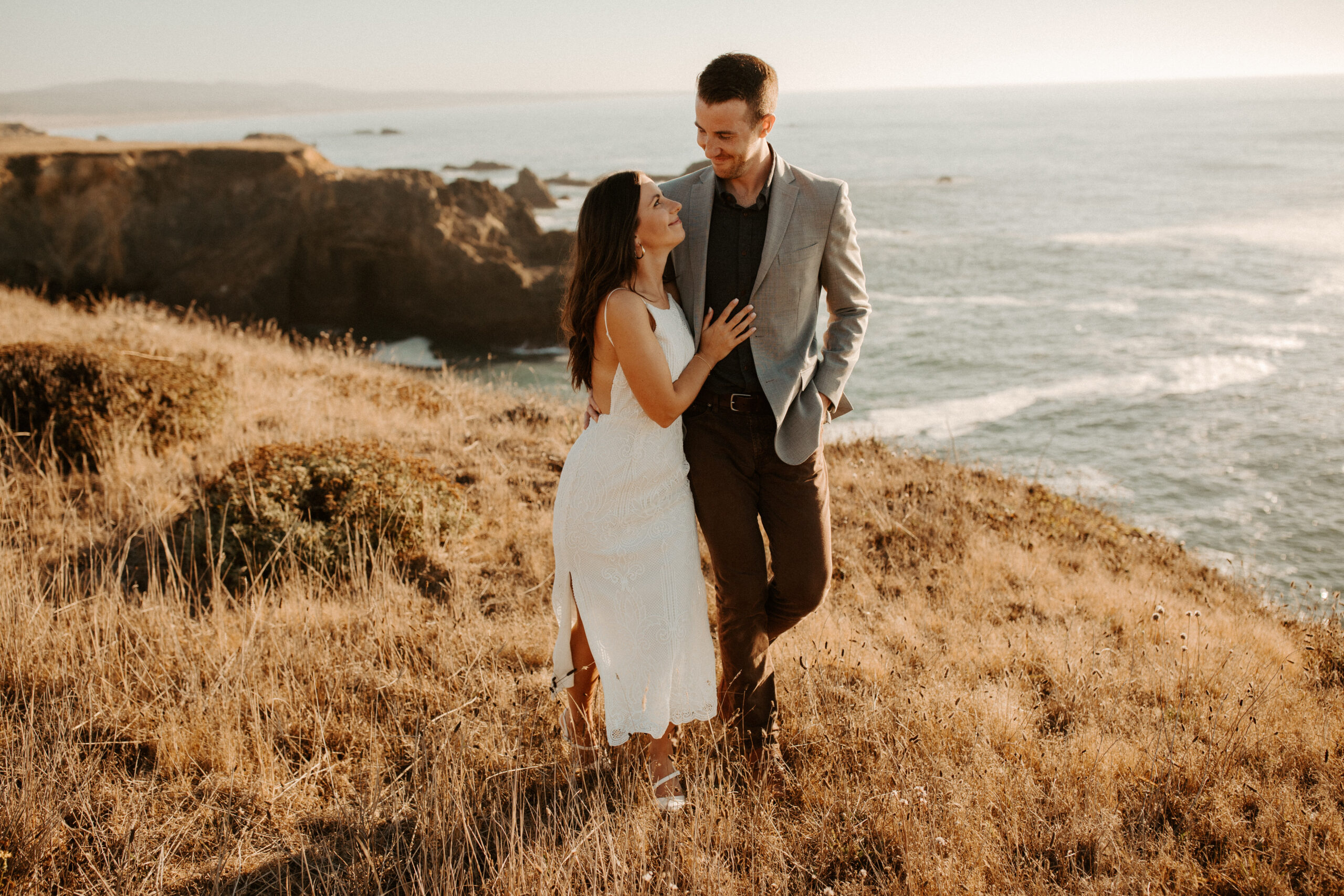 beautiful couple pose with the Pacific ocean in the background, a top tier San Francisco engagement photoshoot location!