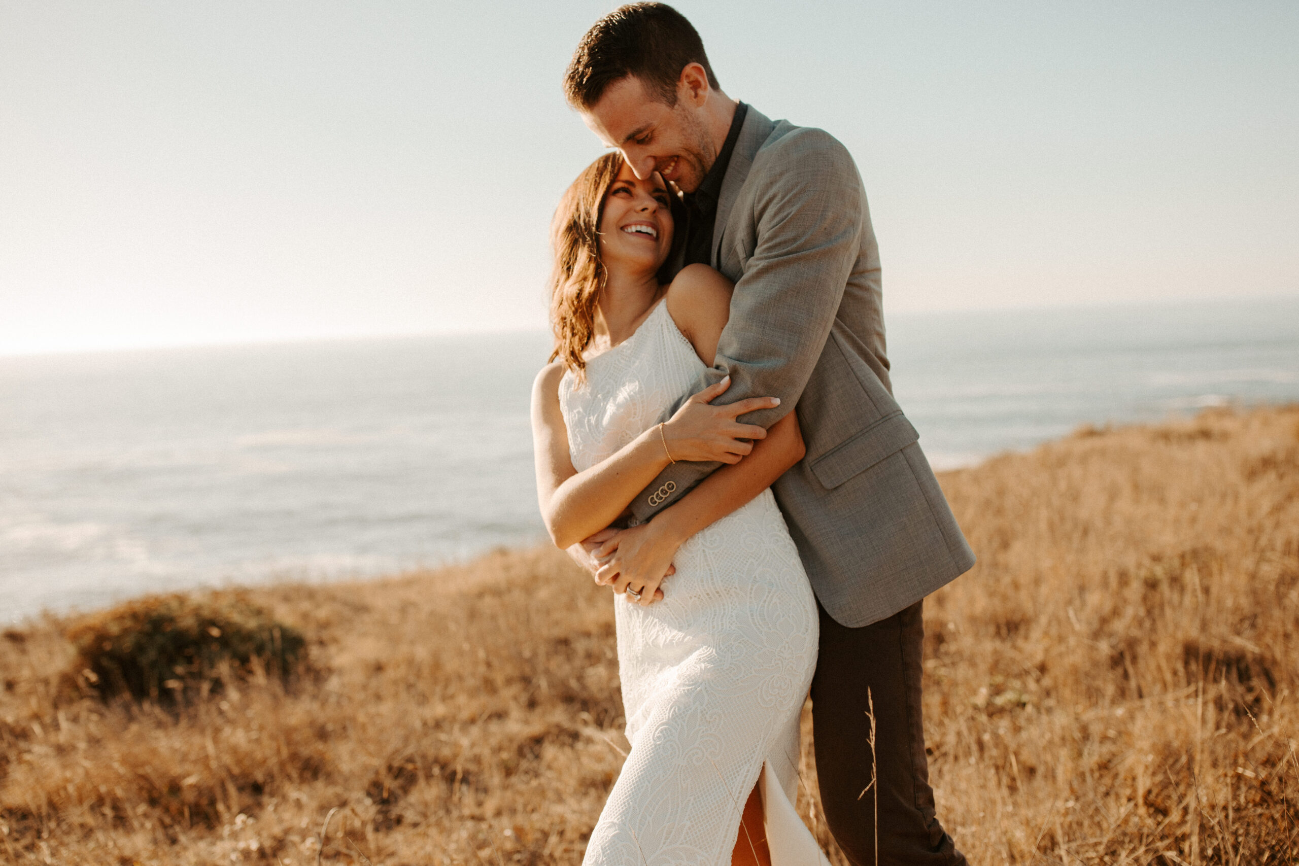 beautiful couple pose with the Pacific ocean in the background, a top tier San Francisco engagement photoshoot location!