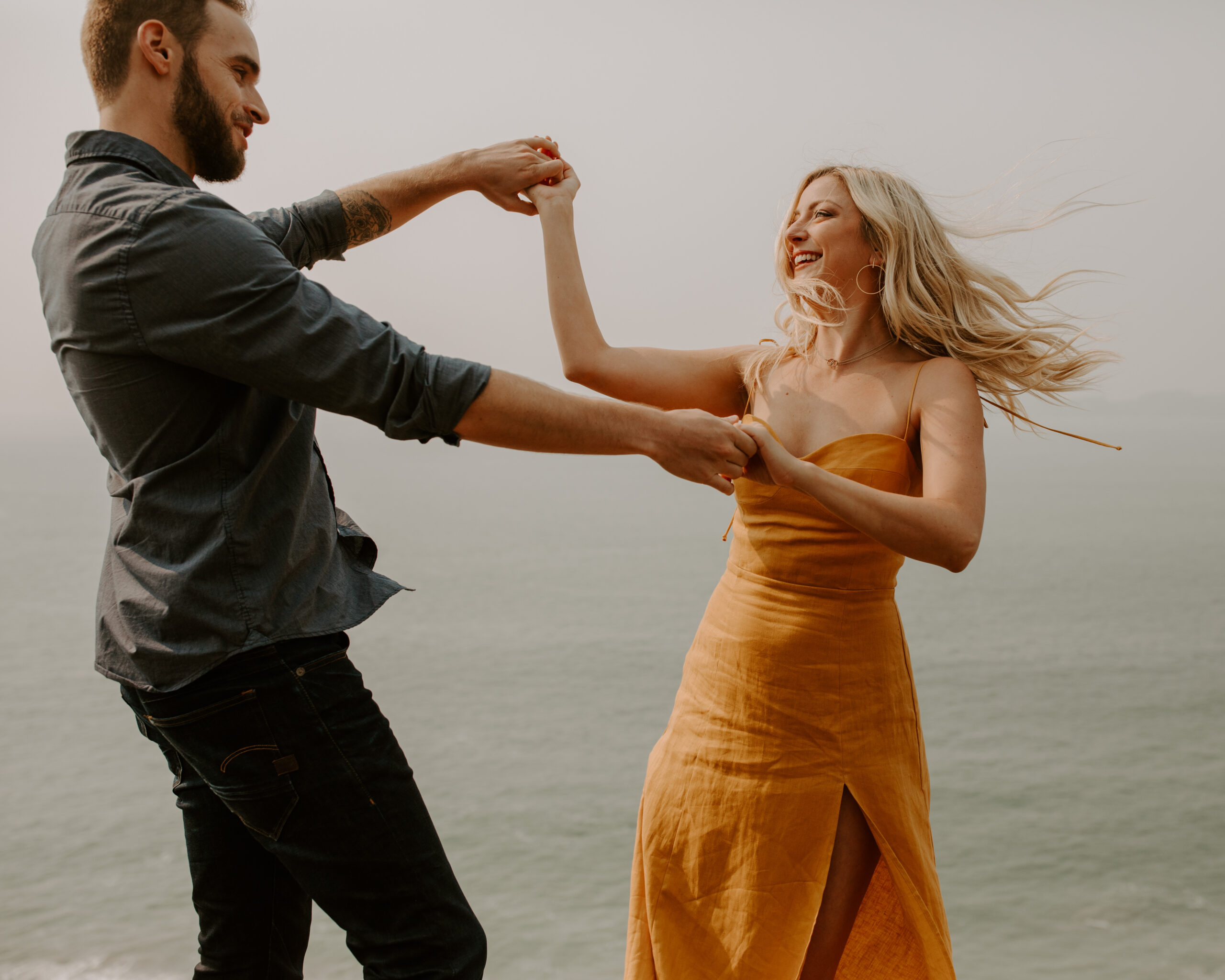 beautiful couple pose with the Pacific ocean in the background, a top tier San Francisco engagement photoshoot location!