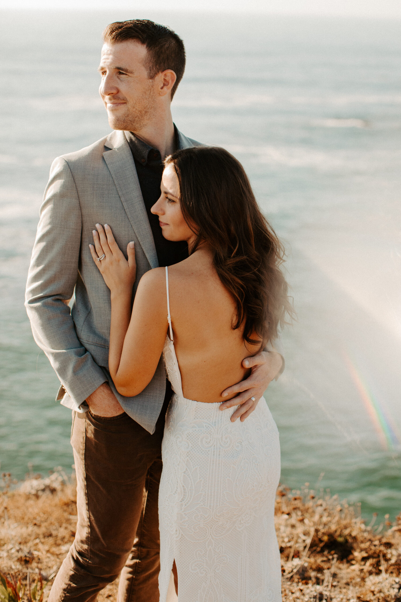 beautiful couple pose with the Pacific ocean in the background, a top tier San Francisco engagement photoshoot location!