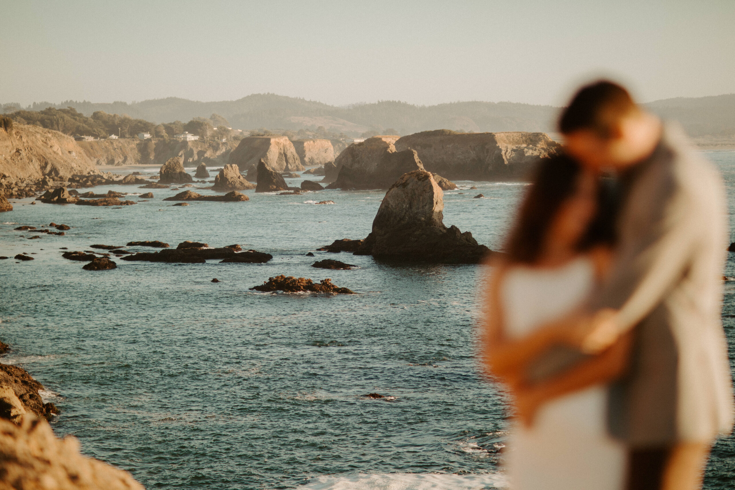 beautiful couple pose with the Pacific ocean in the background, a top tier San Francisco engagement photoshoot location!