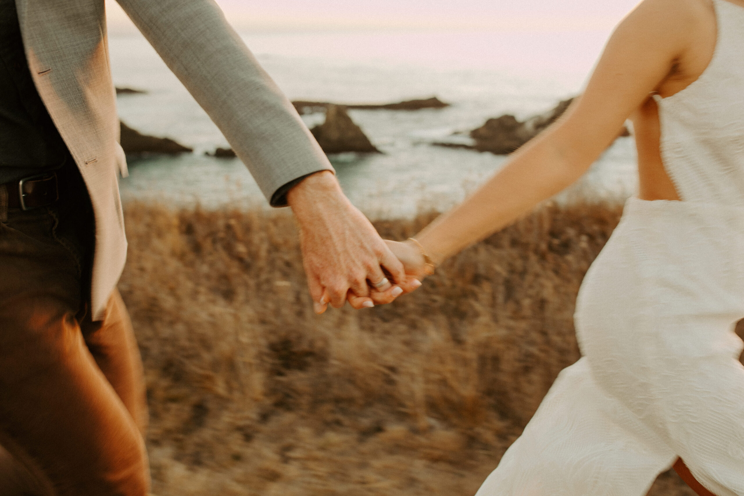 beautiful couple pose with the Pacific ocean in the background, a top tier San Francisco engagement photoshoot location!